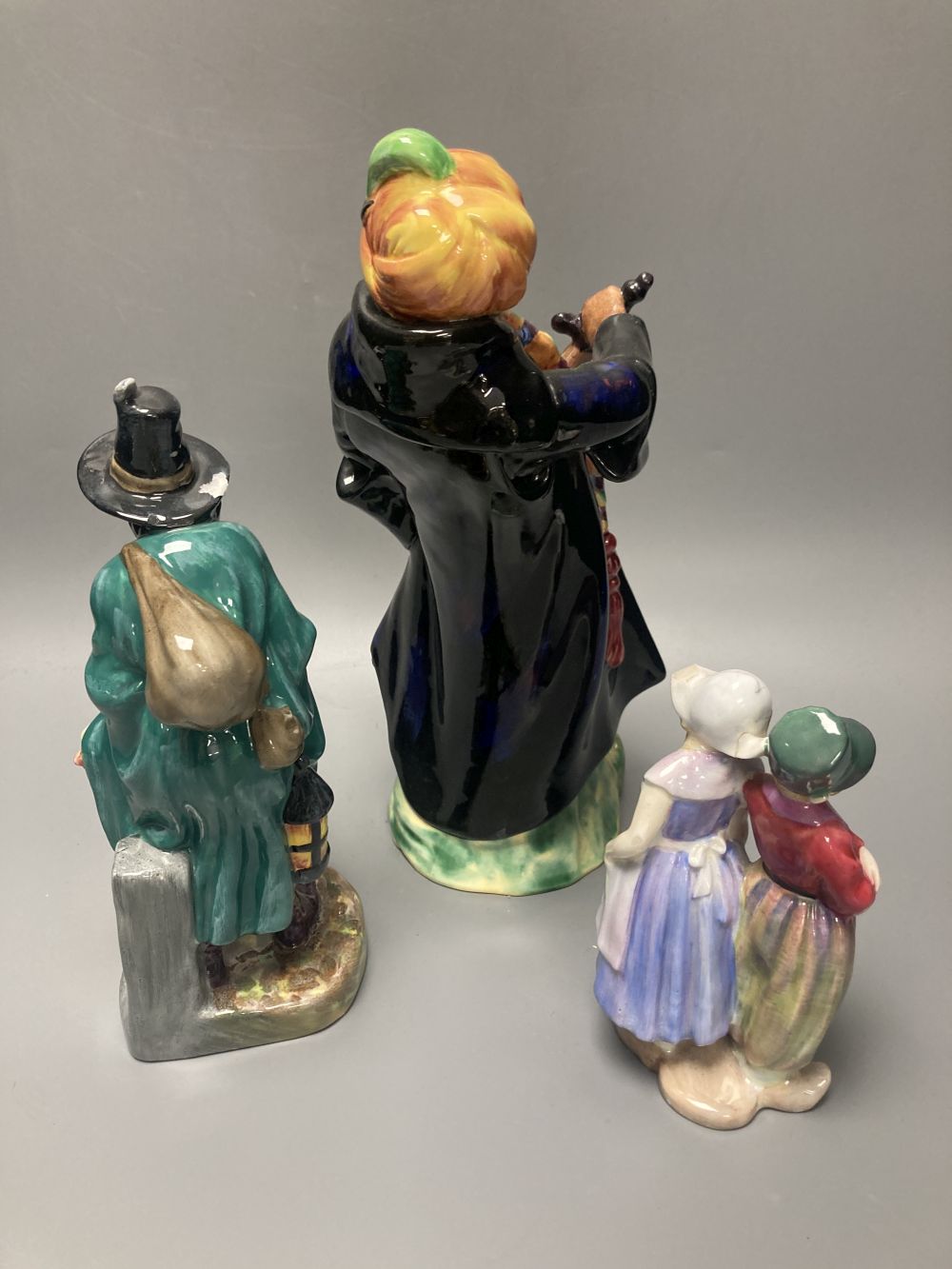 Three Doulton figures: Willy Wont He, HN7818, The Mask Seller, HN2103 and Blue Beard HN2105, tallest 27cm